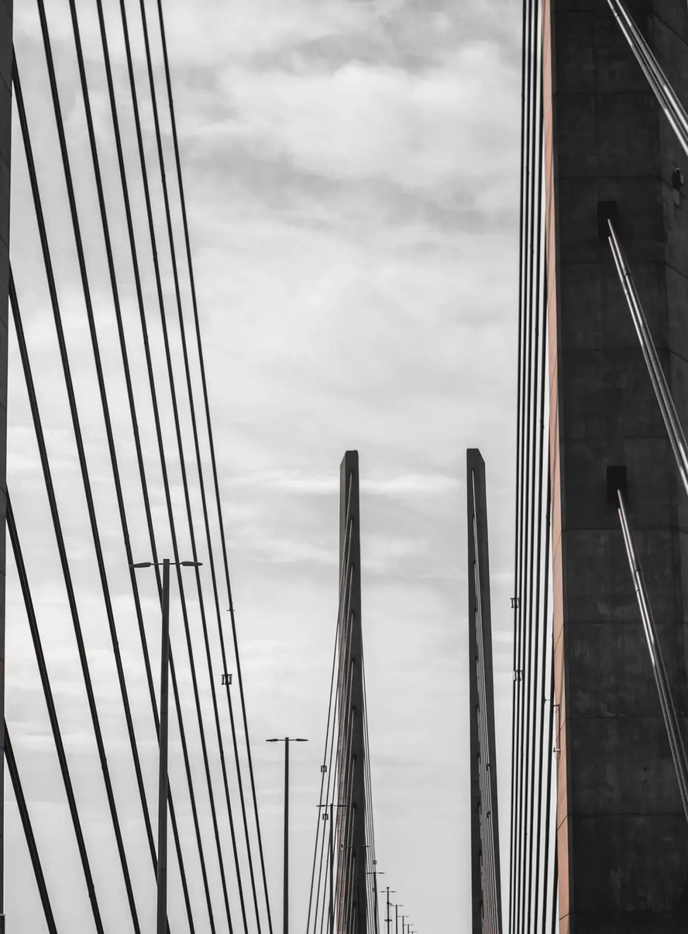 Black and orange metal frame under white clouds